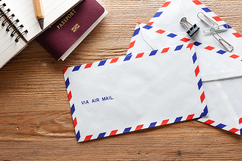 Air mail envelope on the wood table