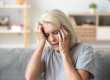 Close up aged woman suffering from headache,