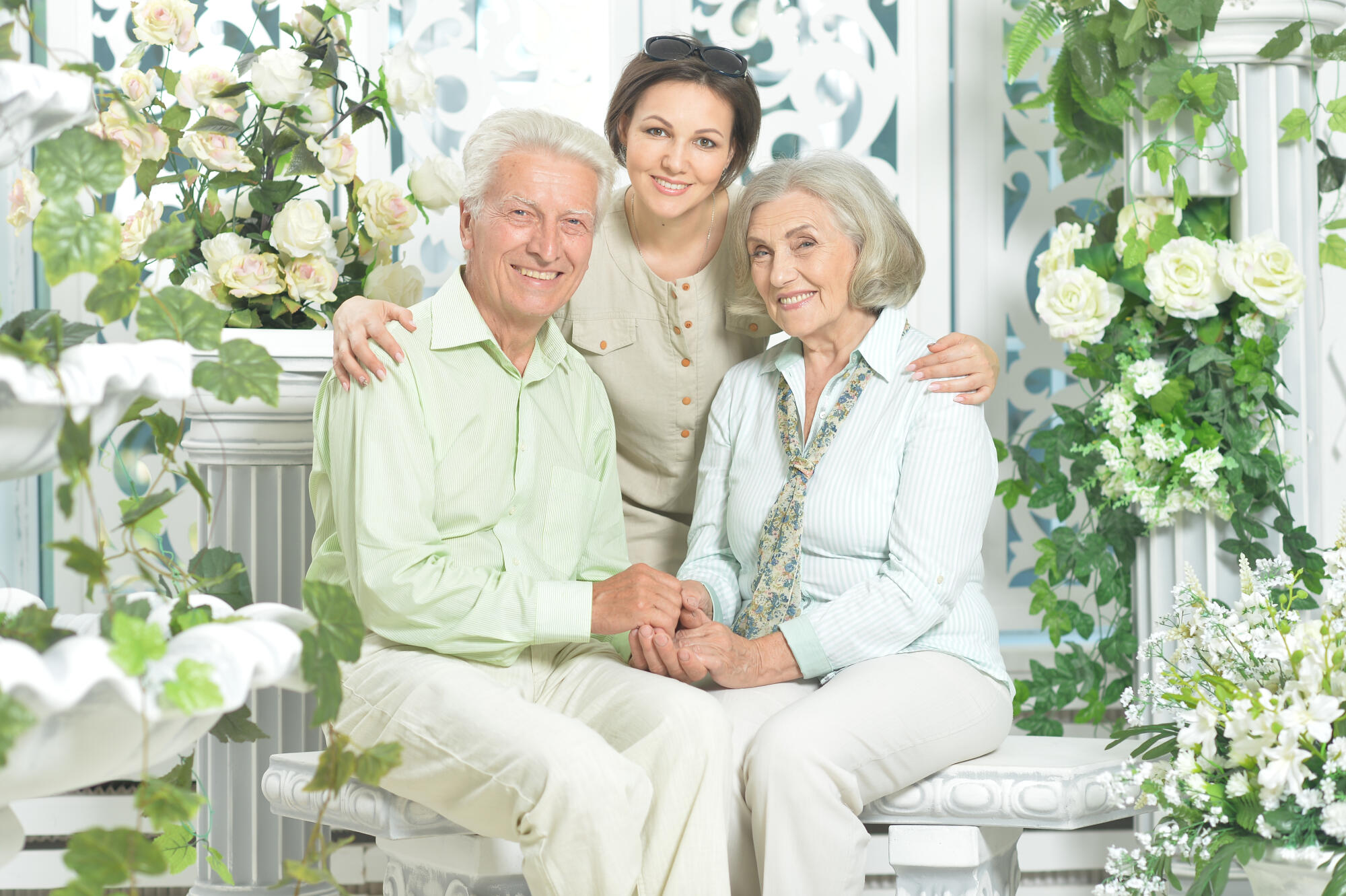 Portrait of happy senior couple with adult daughter