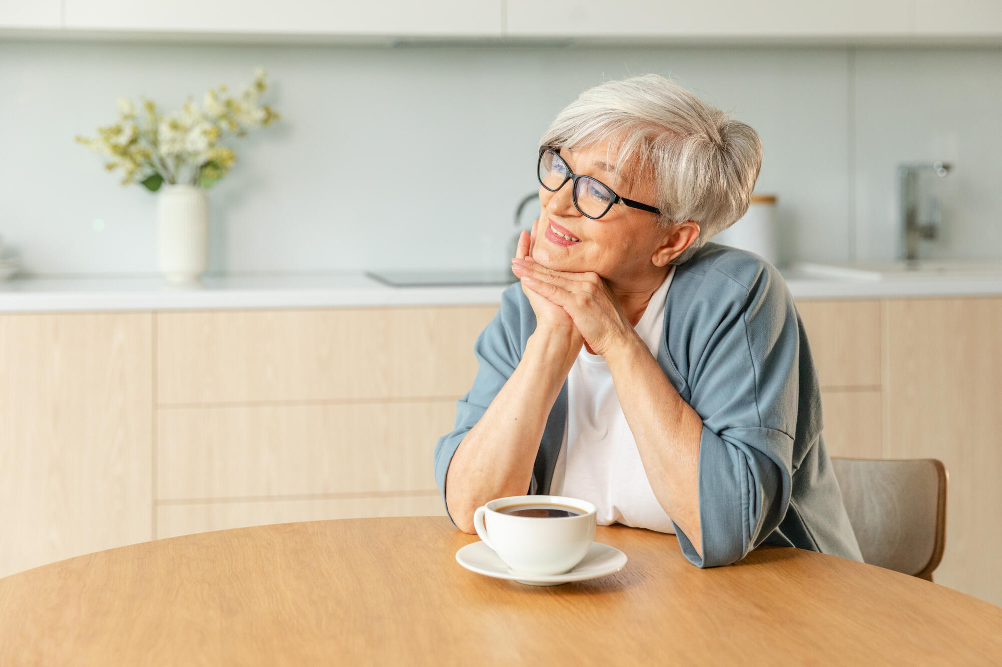 Good morning. Comfort relaxed senior old elderly woman grandmother drinking hot beverage tea coffee in kitchen at home. Mature woman resting enjoy calm morning at modern home alone. Pension concept.